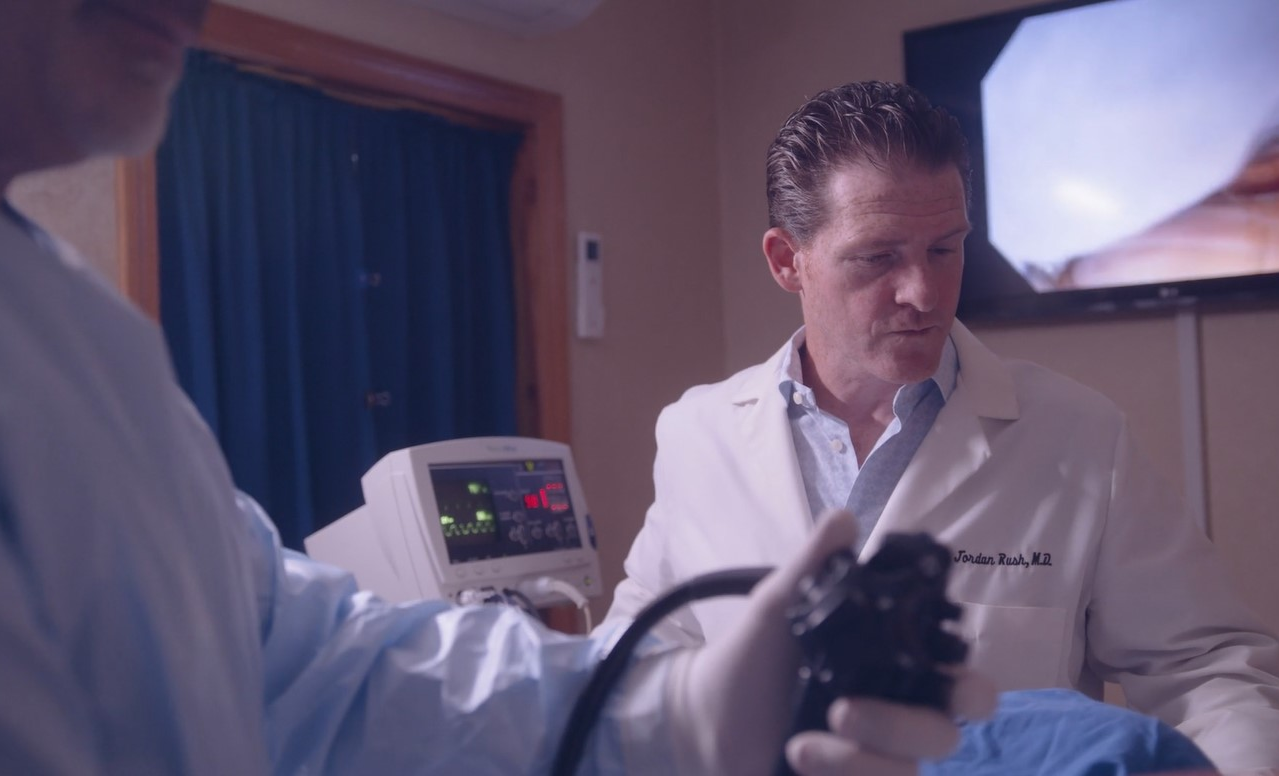 A physician performing a colonoscopy.